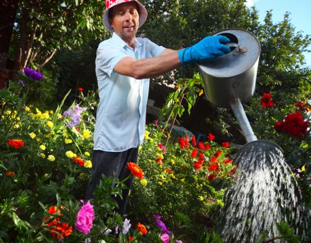 Supervisor checking safe working practices in a garden area